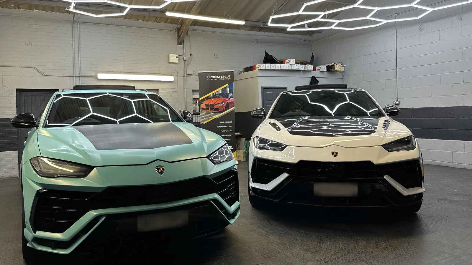 Two Lamborghini Urus under the hexagon lighting in our Braintree studio