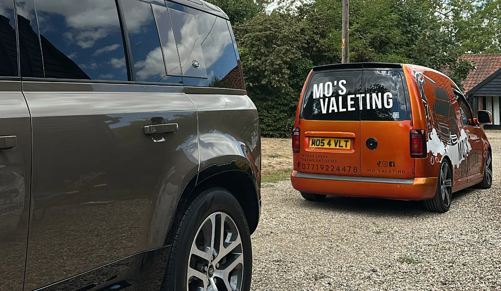 A Mo&rsquo;s Valeting van parked beside a customer&rsquo;s Land Rover Defender