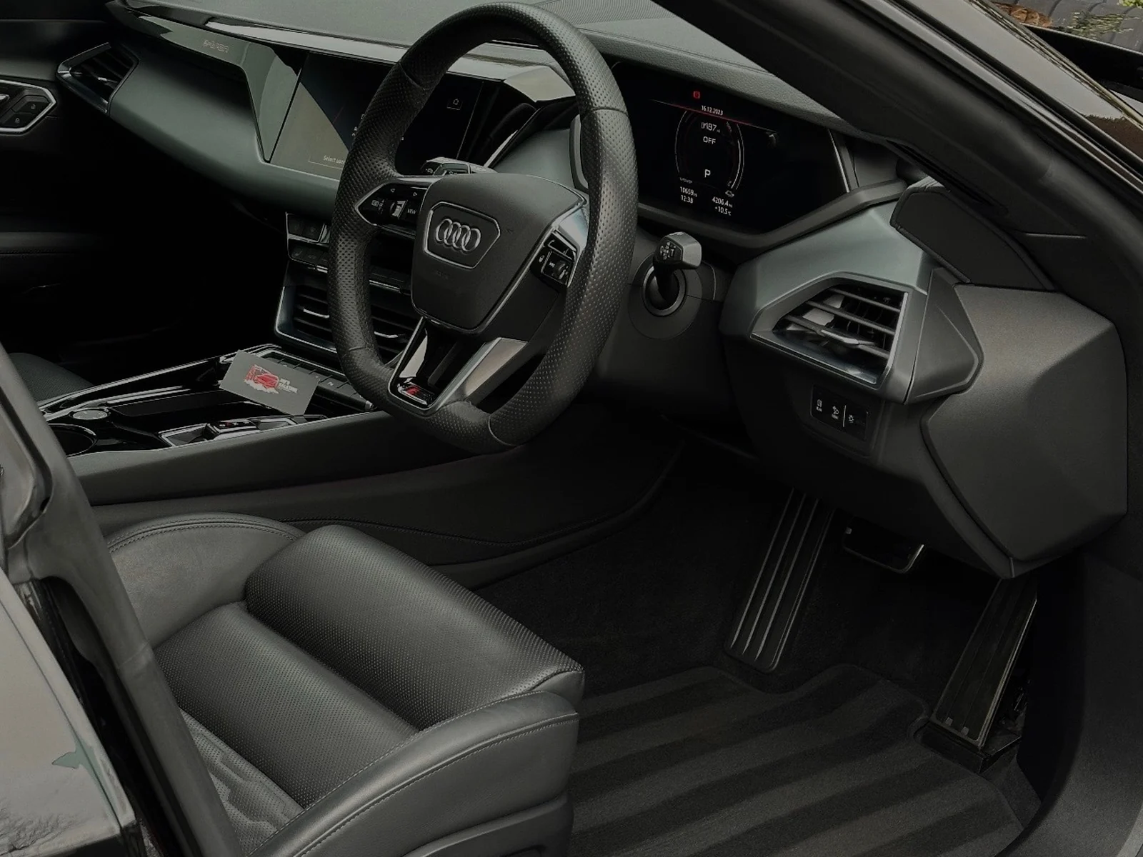 The cleaned driver's side interior of a car, showing the steering wheel, screens and seat