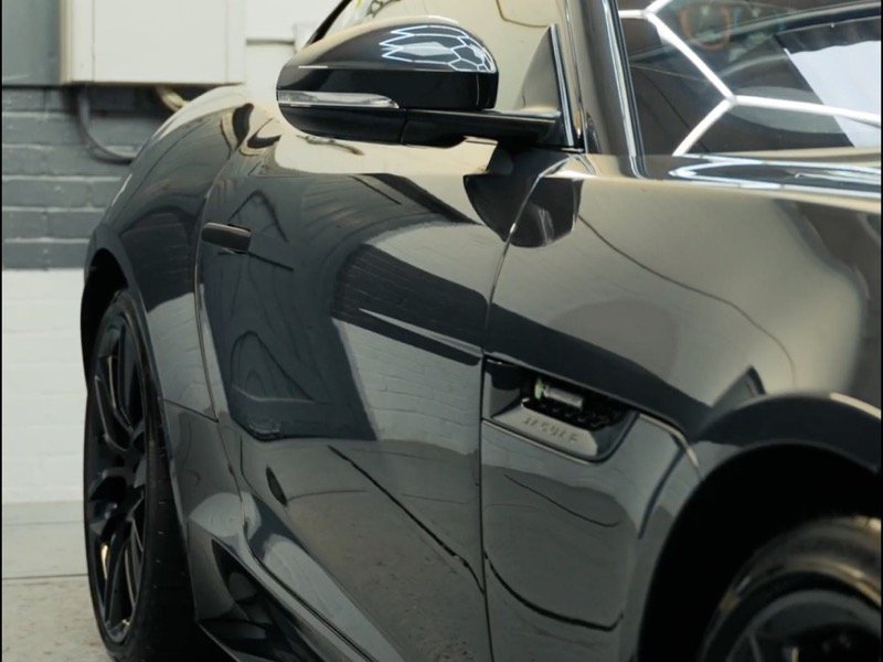 Deep gloss paint correction finish on a black sports car